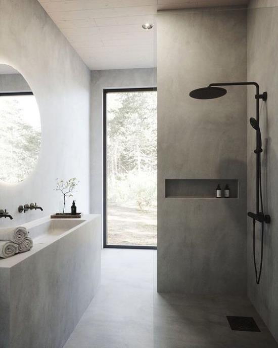 Kylpyhuoneen mallit harmaa, kaunis kylpyhuone, suihkunurkka, musta hana, pitkä turhamaisuus, lasiovi, pyöreä seinäpeili