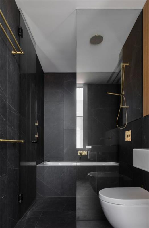 Kylpyhuone musta ja kultainen minimalistinen harmaa elementti virkistää yksinkertaista muotoilua