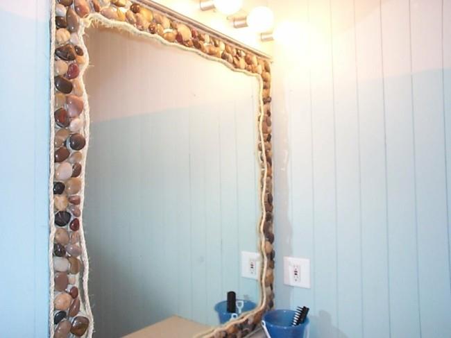 Kylpyhuoneen peili, jonka ympärillä on joen kiviä