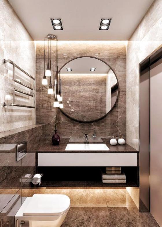 Ruskea moderni kylpyhuone pyöreä peili suurikokoiset marmorilaatat hyvä valaistus