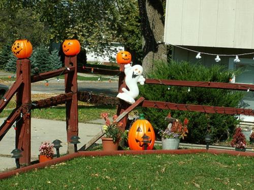 Viileä juhlakoriste puutarhassa Halloween -kurpitsan maalatuille kasvoille