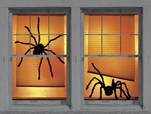 Halloween -ikkunakoriste kaksi suurta mustaa hämähäkkiä oranssi tausta hyvin valaistu.