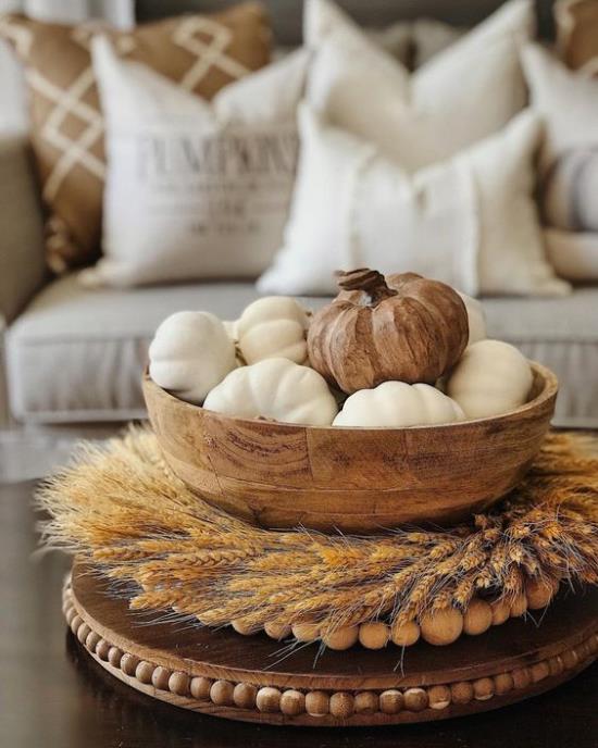 Syksyn koristelu vehnän seppelellä sohvapöydällä Pohja kurpitsan koristeluun puukulhoon