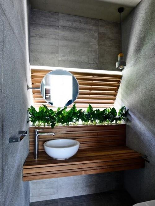 Puiset kylpyhuonekasvit tekevät betonikylpyhuoneesta kodikkaan