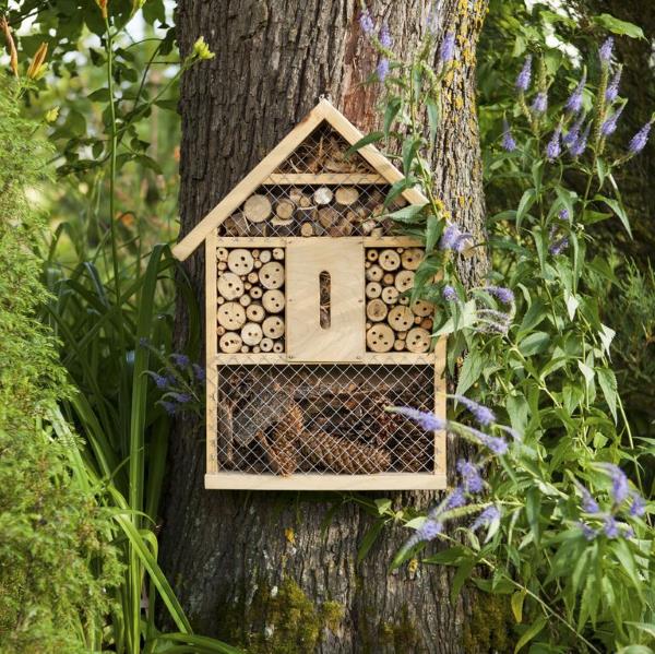 Tinker hyönteisten hotelli ja täytä kevätpuutarha iloisella buzz mehiläisillä hotelliympäristö luonto