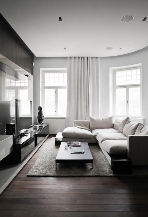 Minimalismi olohuoneessa täydellinen muotoilu valkoinen sohvasetti harmaa matto musta pöytä harmaa verhot