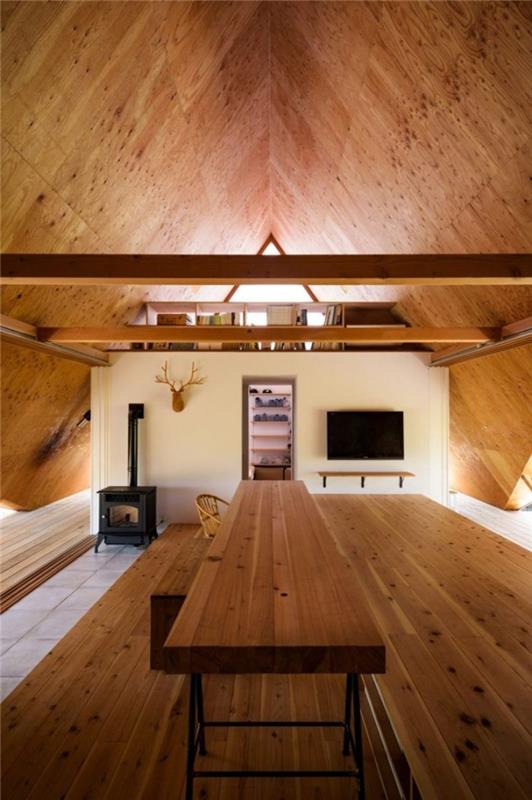 Minimalistinen talo Japanissa teltan muodossa kahdessa tasossa olohuoneessa, joka on erotettu puusta valmistetusta kirjahyllystä