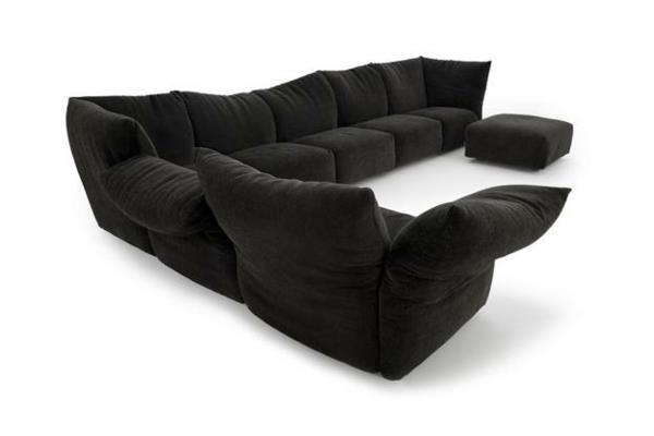 Moderni sohva kukkasohvan muodossa musta ottomaani