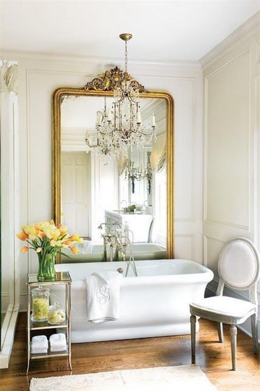 Pariisin tyylikäs kylpyhuoneessa moderni kylpyamme iso seinäpeili koristeellinen runko sivupöytä kukat kattokruunu tuoli