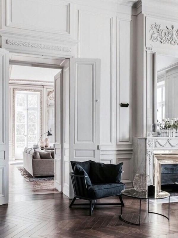 Pariisin tyylikäs olohuoneessa valkoinen tai vaaleanharmaa hallitseva väri musta nojatuoli katseenvangitsijana