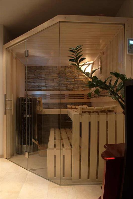 Sauna kotona Ota saunan kiviseinä, puiset penkit lasiseinän takana, tyylikäs muotoilu