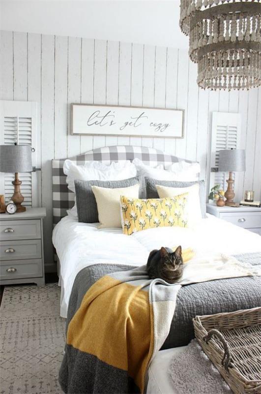 Makuuhuoneideoita harmaassa ja keltaisessa kutsuvassa huoneessa visuaalisesti tasapainoinen kissa sängyllä