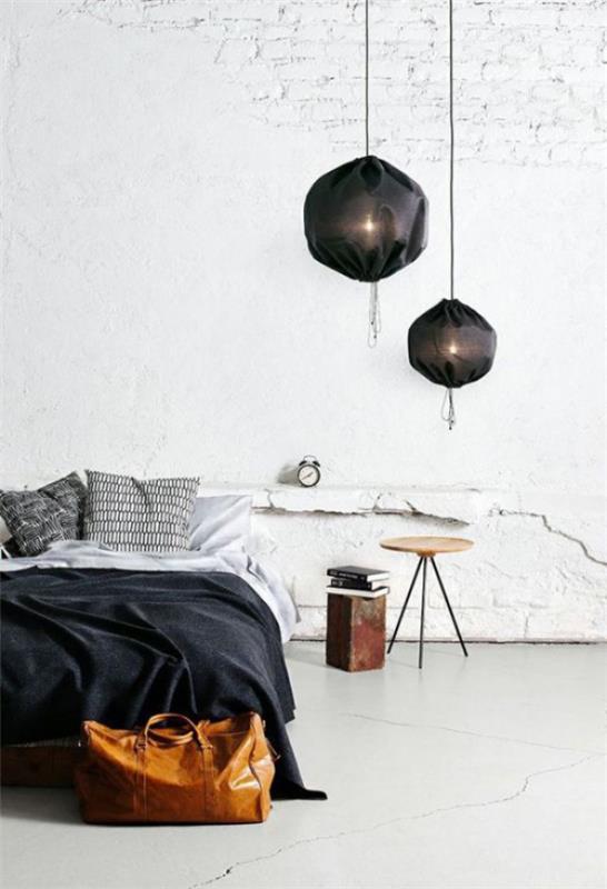 Makuuhuoneen minimalistinen minimalismi teollisella tyylillä mate tiiliseinä betonilattia