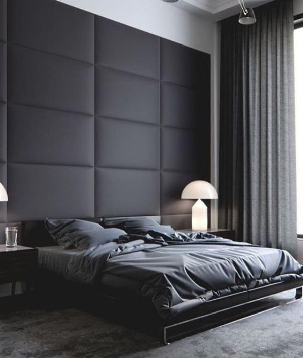 Musta aidattu tyylikäs makuuhuone, jossa musta nahkapehmustettu aksentti -seinä nukkumissängyn takana harmaat verhot vuodevaatteet harmaa matto