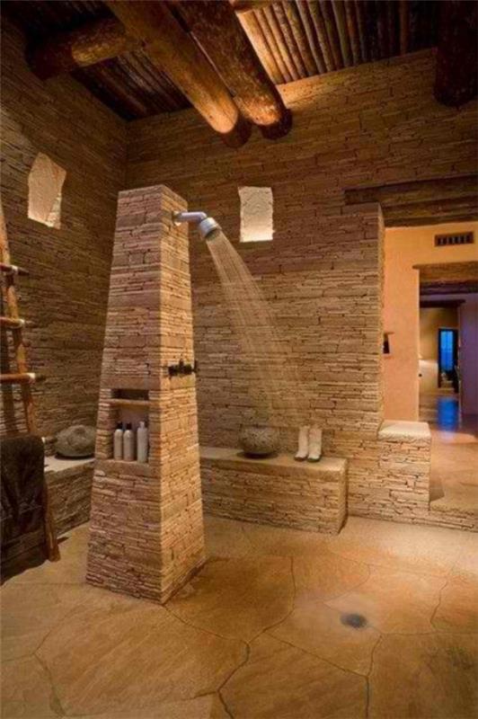Kivi kylpyhuoneessa laajan luonnonmateriaalisuihkun käyttö suuren huoneen keskellä