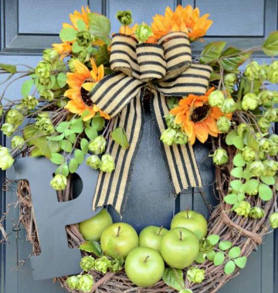 Oven seppele omenoilla, vihreillä omenoilla, auringonkukilla, oksilla, suurella keulalla, kauniilla ovikoristeella