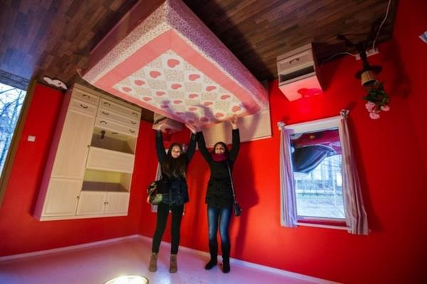 Käänteinen talo Venäjällä punainen seinäsänky vaatekaapissa