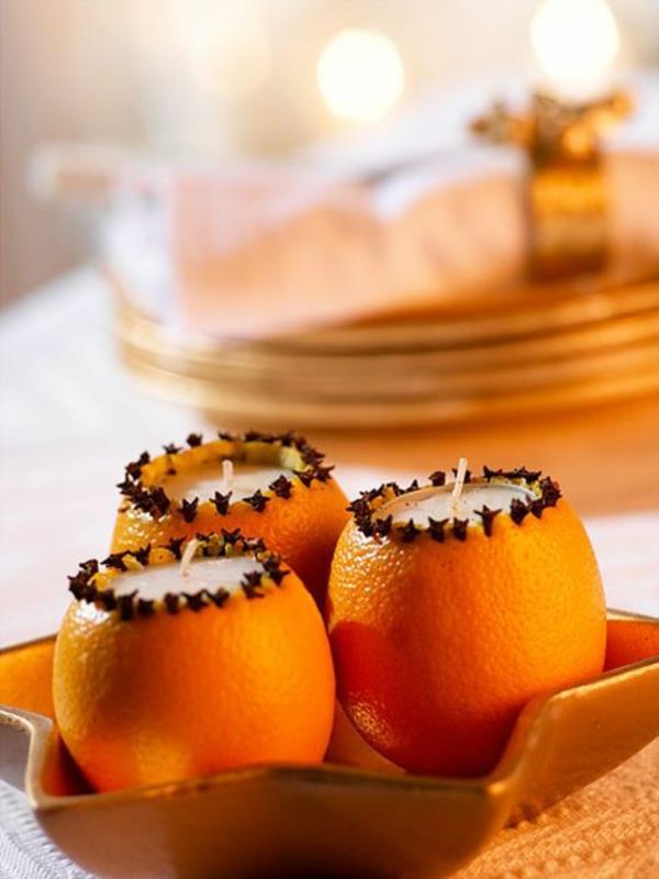 Tee joulukoristeista appelsiinit kynttilänjaloiksi