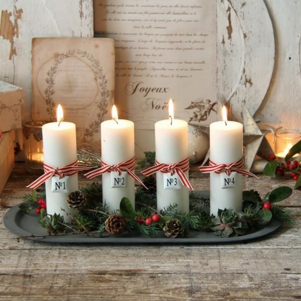 Tee oma adventtiseppele lautaselle, jossa on käpyjä ja valkoisia kynttilöitä