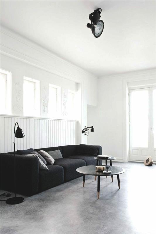 betonilattia olohuone minimalistinen musta sohva