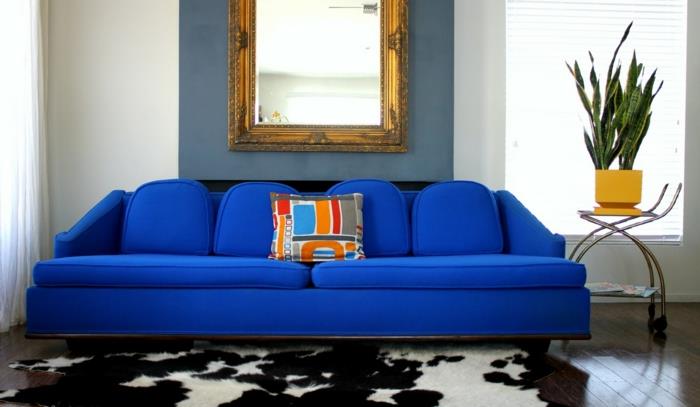 sininen sohva turkimatto valkoiset verhot seinäkoriste
