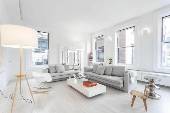 värisuunnittelu olohuone valkoiset seinät vaaleanharmaat sohvat valkoinen sohvapöytä lattiavalaisin
