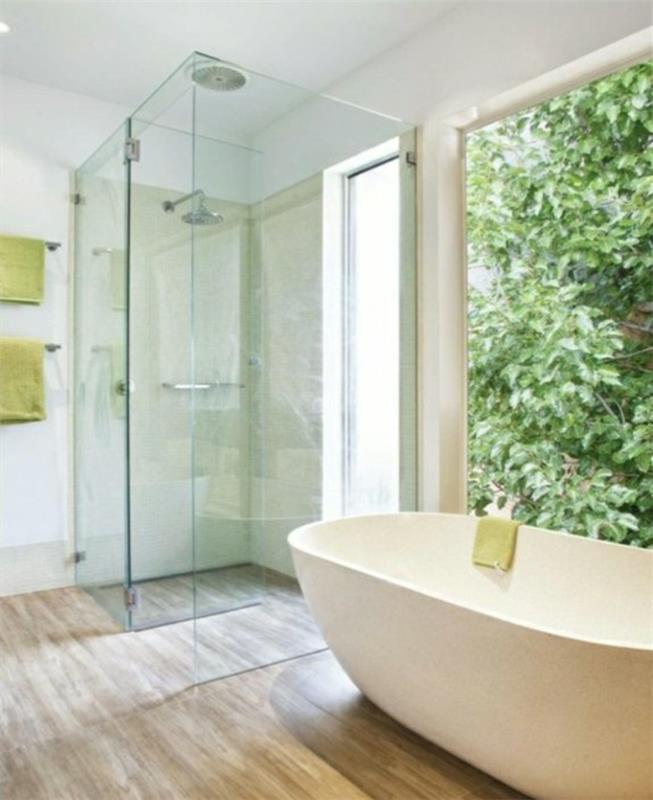 vapaasti seisova kylpyamme puulattia kylpyhuoneessa suihkukaappi lasiovet
