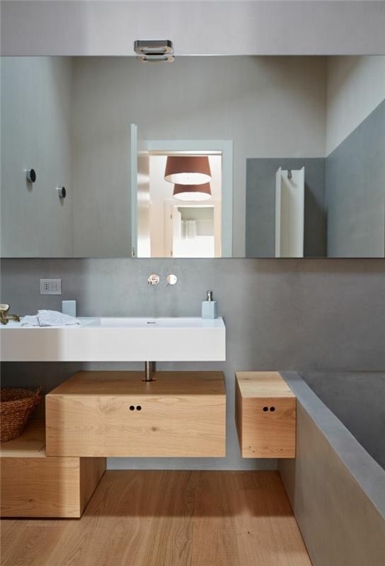 saumaton kylpyhuone harmaat seinät puukalusteet kaunis lattia