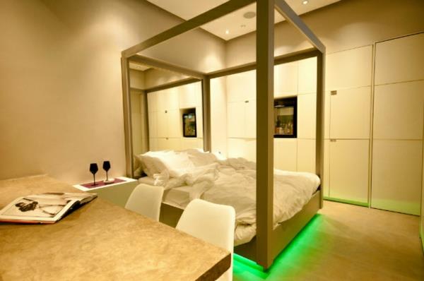 futuristinen makuuhuone suunnittelee vihreää neonvaloa sängyn alle