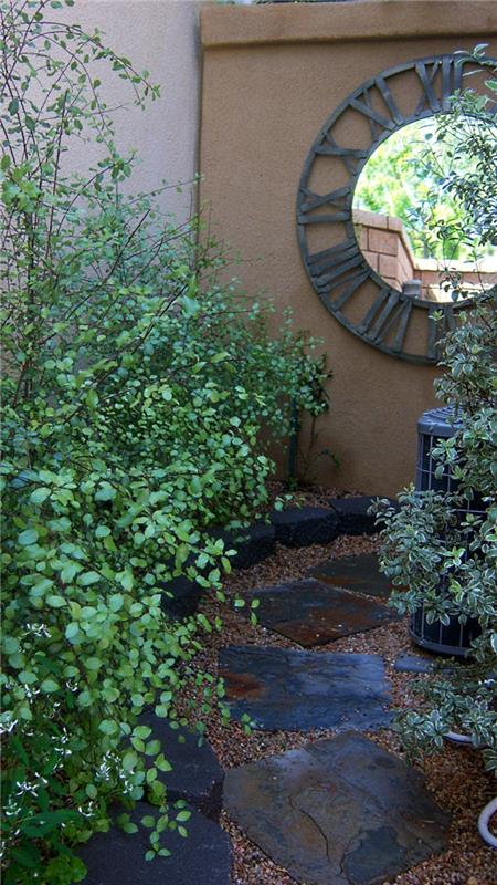 puutarha suunnittelu puutarhapolku kasvit viileä aksentti seinä