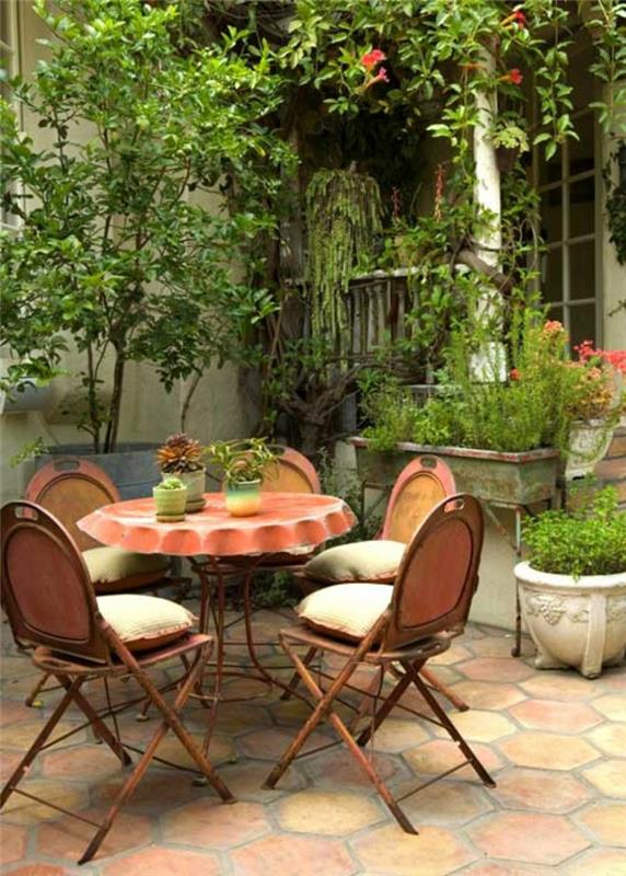 ideoita puutarhasuunnittelu pyöreä metallipöytä maalaismainen puutarhapöytä