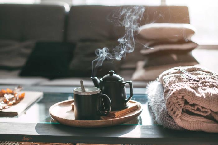 Pysy terveenä ja onnellisena talvella sohvapöydällä tuoksuvat aromaattiset teet ja tuoksut sen vieressä