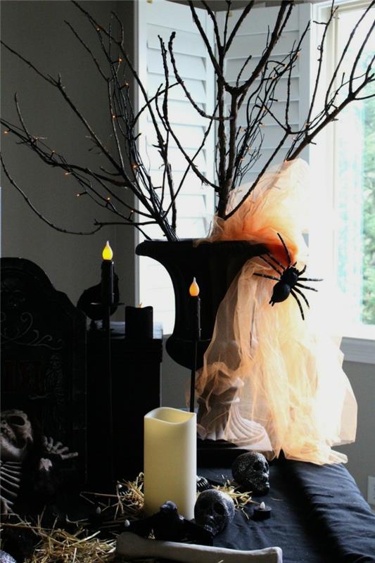 halloween -sisustus tyylikäs sisustus kynttilöillä ja oksilla