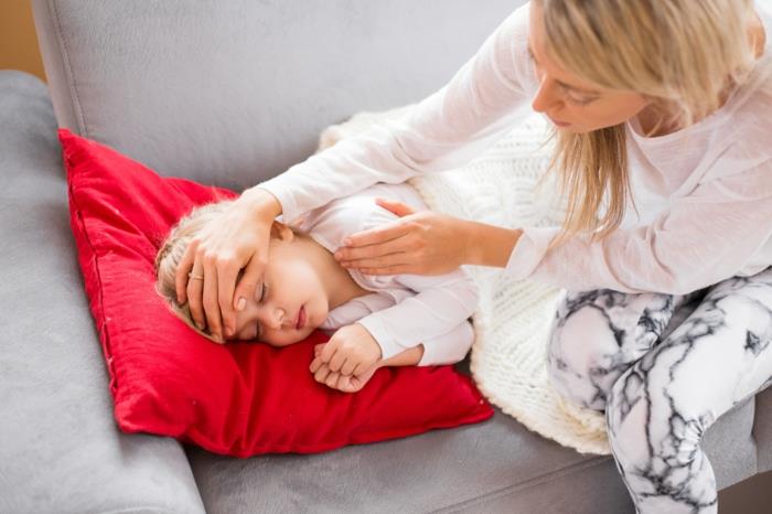 Äiti hoitaa sairasta lastaan ​​kotona
