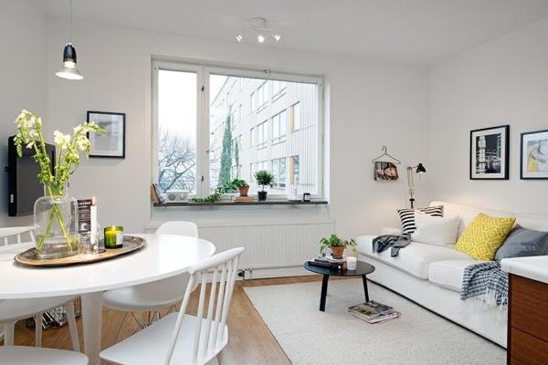 valoisa ja viihtyisästi sisustettu huoneisto, jossa on ruokapöytä