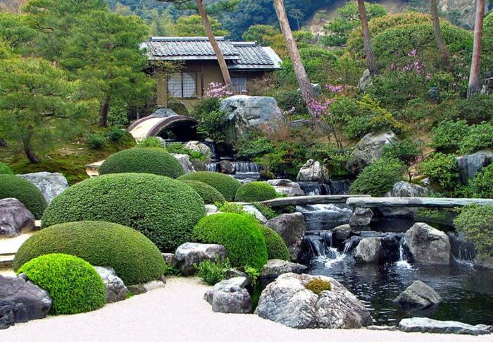 japanilainen puutarha iso puisto vesiputouksia suuret luonnonkivet puutarhavaja pensaat havupuut