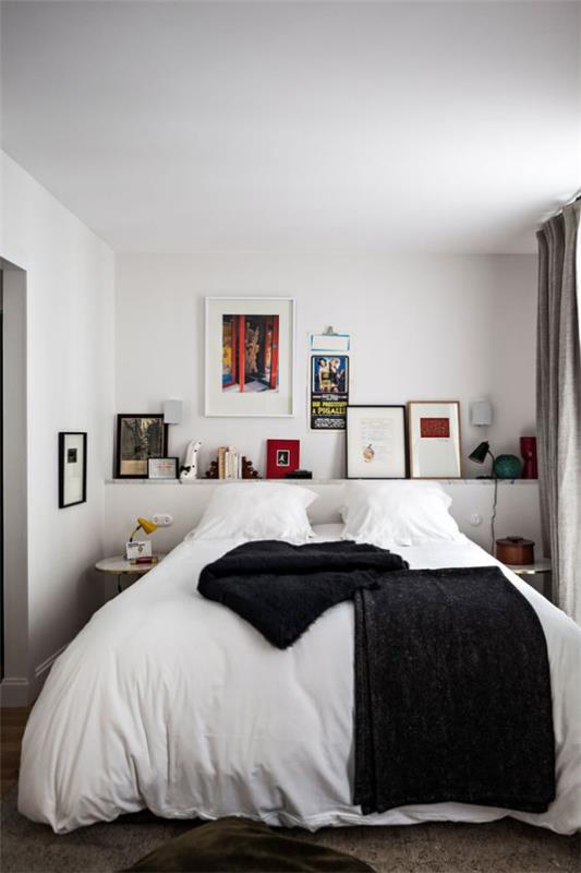 pieni makuuhuone yksinkertainen sisustus nukkuva sänky valkoinen pellavahylly korostuu mustalla kontrastilla