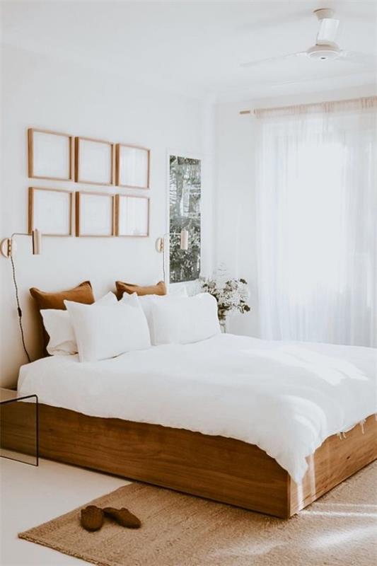 pieni makuuhuone visuaalisesti laajentaa puinen nukkumissänky valkoinen vuodevaatteet tyynyt seinäkoriste ikkuna paljon valoa