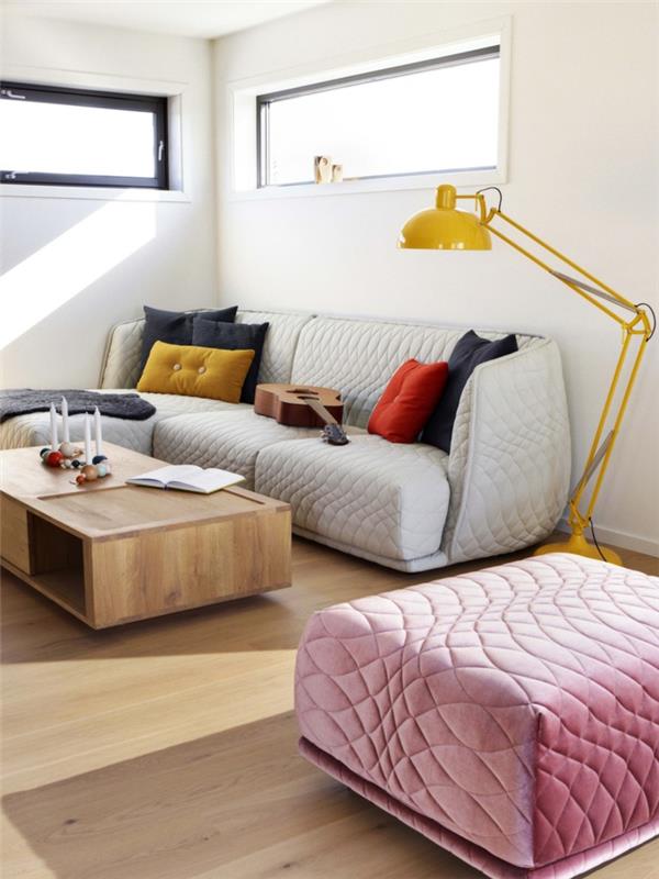 Pieni olohuone sisustus pastellivärit keltainen lattiavalaisin valkoinen sohva vaaleanpunainen jakkara