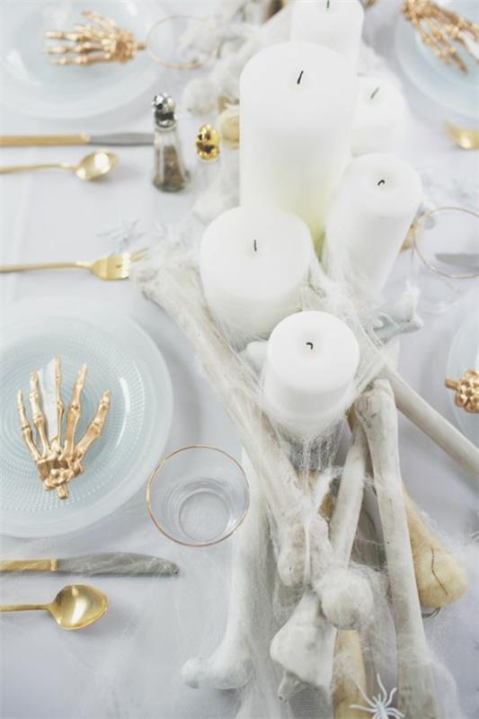 ylellinen halloween -pöytäkoriste luuranko luut valkoiset kynttilät kulta