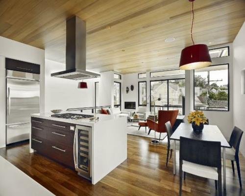 moderni-keittiö-nykyinen-suunnittelu-työtasot-ruokailutila-riippuvalaisin-punainen