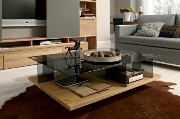 moderni olohuoneen kalusteet ruskeasta turkista valmistetulla pöytälevyllä, joka on valmistettu tummasta lasista