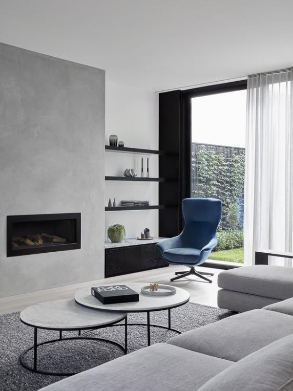 moderni olohuone harmaa perusvärinä pieni musta aksentti klassinen sininen nojatuoli katseenvangitsijana