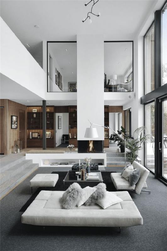 moderni olohuone kahdessa tasossa tyylikäs sisustus valkoiset huonekalut harmaa lattiakaarilamppu heittää tyynyjä sohville