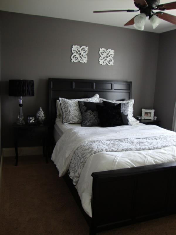 makuuhuoneen seinän väri harmaa sävyt puinen sänky yöpöydän matto