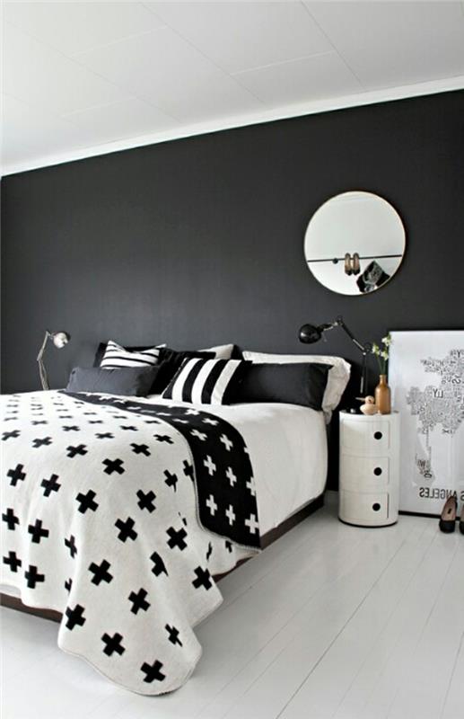 makuuhuoneen sisustus musta seinä valkoinen lattia vuodevaatteet