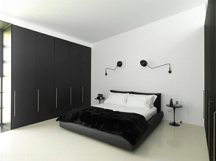 makuuhuoneen sisustus musta vaatekaappi seinävalaisimet valkoiset seinät