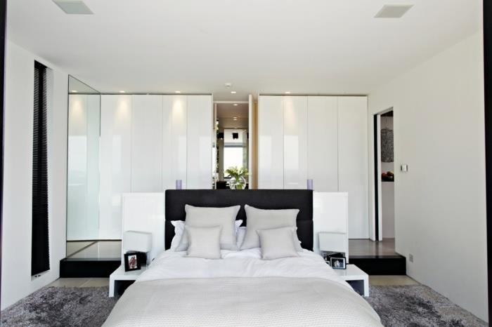 makuuhuone valkoinen harmaa matto moderni vaatekaappi musta vuode pääty