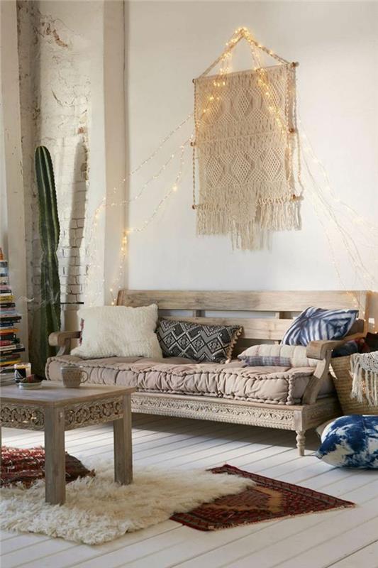 nuhjuiset tyylikkäät huonekalut boho -tyylinen puuveistos macrame -tyynyt etniset matot lampaannahka puulattiat keiju valot sohva