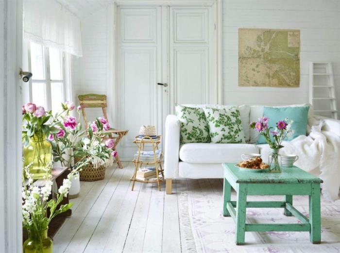 nuhjuinen tyylikäs olohuone vihreä sohvapöytä kasvit